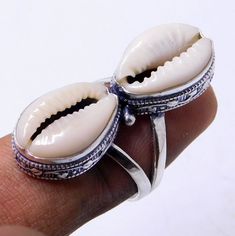 Weight of ring 7 Gm, 100% Made with high quality genuine natural money Cowrie Sea Shell Ring Dimensions Stone With Silver (Length 35 Millimeter) Stone With Silver (width 12 Millimeter) Stamped: 925 i make jewelry for a very special kind of Women's men's ,This stunning is handcrafted by one of our talented artisans. It is set in precious Fine Jewelry 925 Sterling Silver Jewelry, Polished to a brilliant luster> Cowrie shells meaning Cowrie shells are known as the most successful and the best form Shells Meaning, Cowrie Shell Jewelry, Cowrie Shells, Shell Ring, Cowrie Shell, Shell Jewelry, Boho Ring, 925 Jewelry, Sea Shell