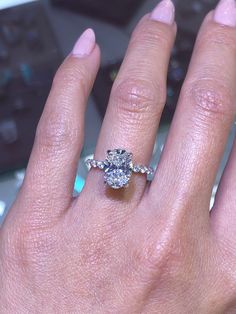 a woman's hand with a diamond ring on it