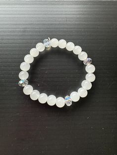 Beautiful white bracelet White Elegant Beaded Bracelets With Gemstone Beads, Elegant White Stretch Bracelet With 8mm Beads, Elegant White Pearl Bracelet With Spacer Beads, White Crystal Bracelet With Gemstone Beads As Gift, White Stretch Bracelet With Round Beads For Gift, White Hand-strung Stretch Bracelet Gift, White Crystal Bracelet With 8mm Beads, Elegant Gemstone Beads Stretch Bangle, White Casual Beaded Bracelets With Gemstone Beads