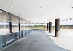 an empty room with glass walls and columns