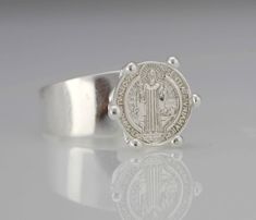 "This Beautiful and Traditional Saint Benedict ring made from high-quality Sterling Silver 925 Its the perfect gift for anyone of any age and excellent for everyday wear. Item Specifications: Model # PAS29M Metal Type: Sterling Silver Oxidize Metal Stamp: 925 Shape St. Benedict Style: Solid Medal Diameter: (approx 13mm-- 1/2 inch) Height from band (approx 8mm--- 5/16 inch) Band Width: Back: 5mm--- 3/16 inch Front: 9mm-- 3/8inch Stones: No * We only sell SOLID metals Stamp: 925 Sterling Silver. - Sterling Silver Open Band Signet Ring Gift, Silver Signet Ring With Open Band As Gift, Silver Open Band Signet Ring As Gift, St Benedict Cross, 15 Rings, Saint Benedict, St Benedict, Silver Prices, Solid Metal