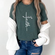 This trendy faith t-shirt with Bible verse is a fashion-forward way to wear your faith in style.  It's versatile to go with many fashion outfits for any season!  Pair it with jeans and your favorite fall shacket for a classy fall fashion or keep it casual with leggings and a cozy flannel or denim button-up shirt.   Christian t-shirts are a great way to express your faith with confidence, comfort, and style! This faith t-shirt is a unique faith design in the shape of a cross with Ephesians 2:8 Bi Classy Fall Fashion, Ephesians 2 8, Faith Design, Cross Shirt, Ephesians 2, Cross Shirts, Faith Cross, Christian T Shirts, Patriotic Outfit