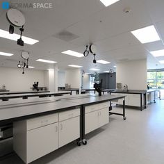 an empty room with several tables and lights on the ceiling is shown in black and white