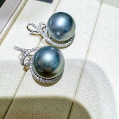 Highlights: The platinum-gray Tahitian pearl always lends the woman who wears it an air of mystery, complemented by noble elegance. Product Information OriginTahitian Pearl Jewelry Processed in Japan MaterialTahitian Pearl and 18k Gold DimensionsEarrings Length Approx. 2.0 mm  Pearl Shaped: Round Size: 13-14 mm Quality: AAAA Nacre: Very Thick Color: Platinum Luster: Aurora  Accessories Metal: 3.3 g of 18k White Gold Other: 0.37 ct of SI Quality Natural Diamond Luxury Gray Jewelry For Formal Occasions, Gray Luxury Jewelry For Formal Occasions, Formal Gray Tahitian Pearl Jewelry, Luxury Tahitian Pearl Earrings In White Gold, Luxury Tahitian Pearl Earrings For Anniversary, Luxury Tahitian Pearl Wedding Earrings, Elegant Gray Jewelry For Evening, Luxury Silver Tahitian Pearl Earrings, Elegant Tahitian Pearl Earrings For Anniversary