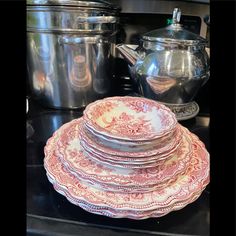 a stack of plates sitting on top of a stove