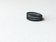 Minimal Iron Ring, Simple Black Ring, Plain Handmade Ring, Dark Grey Ring, Metal Rustic Ring, Raw Wire Ring, Unisex Steel Band, Women Band This simple 3 story iron ring was handmade from an iron wire. Minimal, a little masculine. For someone who likes a little bit of edge. For someone bored with shiny polished girly style rings.  Let me know what size you need! I'll create one just for you. Ring will be packed in a linen satchet and shipped to you in a bubble envelope as soon as possible.  Mater Adjustable Black Rings For Everyday Wear, Minimalist Adjustable Black Rings, Minimalist Handmade Black Ring, Black Adjustable Stackable Rings, Adjustable Black Stackable Rings, Adjustable Black Stackable Open Rings, Adjustable Black Midi Rings For Gift, Grey Ring, Gray Ring