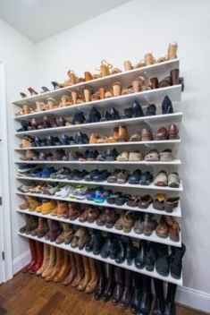 there is a shoe rack with many pairs of shoes on it