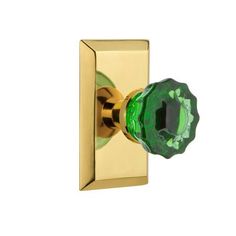 an image of a green knob on a gold plated doorknobl or handle