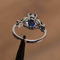 It is a lab sapphire ring. The main stone is 7 mm*9 mm oval cut.weight about 2.32 carats. The basic metal is sterling silver and plated with rhodium. To change the metal to a solid gold (white/rose) or platinum is also available, please ask for a quotation if you want. You can also go to my shop Home for more elegant rings: https://www.etsy.com/shop/godjewelry?ref=hdr_shop_menu Sapphire is September birthstone. More sapphire rings: https://www.etsy.com/shop/godjewelry?section_id=20715031 Customi Silver Oval Sapphire Ring, Sterling Silver Sapphire Ring For Anniversary, Oval Cabochon, Silver Sapphire Oval Cabochon Ring, Silver Sapphire Ring With Oval Cabochon, Oval Lab-created Sapphire Birthstone Ring, Silver Oval Cabochon Sapphire Ring Fine Jewelry, Silver Sapphire Ring, Oval Cabochon, Fine Jewelry, Silver Sapphire Ring Oval Cabochon Fine Jewelry, Elegant Rings