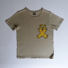 Made In Japan Olive Khaki With Yellow Bear Print Pit To Pit: 19” Shoulder Across: 16” Length: 25” In Worn Condition, Faded Throughout And Pilling/Softness To Fabric, Slightly Misshapen And Very Faint Discoloration Near Front Hem (Photo 7, Hard To See When Wearing) Scary Teddy Bear, Hysteric Glamour, Bear T Shirt, Bear Print, Made In Japan, Colorful Shirts, Teddy Bear, Womens Tops, Tops & Tees