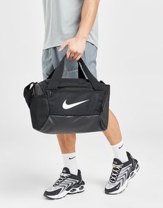 Keep organised with this Brasilia Bag from Nike. In a Black colourway, this bag is made from a light and durable poly fabric that uses at least 50% recycled material. It features a main zippered compartment, a zippered inner compartment to stash sweaty clothes whilst the coated bottom offers lasting wear. With a detachable shoulder strap for custom comfort, it's signed off with the Swoosh to the front. Spot clean. (H: 25.4cm x W: 25.4cm x D: 38.1cm). Nike Windrunner, Nike Air Flight, Nike React Vision, Small Bra, Nike Air Vapormax Plus, Football Socks, Nike Classic, Nike Elite, Nike Tech