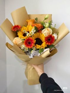 a person holding a bouquet of flowers in their hand