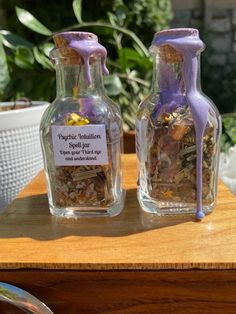 two glass bottles filled with different types of flowers