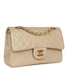 This Vintage Small Classic Double Flap bag is in Beige Lambskin with gold hardware, front flap with CC turnlock closure, tonal stitching, an interwoven gold tone chain link adjustable shoulder/crossbody strap, and signature half moon pocket on exterior.The interior is lined in beige leather with the "love letter" zipper compartment underneath the first flap, an "outer" slit pocket under the second flap, and an interior compartment with two open pockets separated by a "lipstick" compartment.Colle Handbag Wallet, Wallet Accessories, Vintage Chanel, Classic Flap, Flap Bag, Handbag Accessories, Tote Handbags, Chanel Classic, Designer Handbags