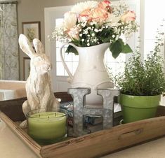 a tray with flowers and candles on top of a counter next to a bathtub