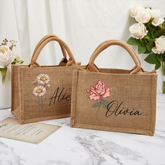 two burlap bags with flowers and name written on them