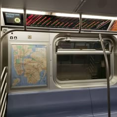 the inside of a subway car with a map on it's wall and railings