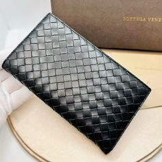 Euc Bottega Veneta Small Black Intrecciato Leather Agenda Cover Collecting Functional Stationery Items Will Be Fun With This Superb Agenda Cover From Bottega Veneta. Exhibiting The Iconic Intrecciato Weave On The Exterior, This Cover Is Made From Black Leather And Reveals A Neatly-Lined Interior. It Is Fitted With Gold-Tone Hardware For A Polished Effect. Approx. Size: 7" X 4.25" Details: Black Intrecciato Leather Smooth Black Interior Leather Interior Pockets Gold Tone Hardware Made In Italy Co Designer Black Leather Wallet, Classic Black Wallet, Luxury Black Wallet, High-end Black Wallet For Formal Occasions, Elegant Black Formal Wallets, Luxury Black Wallets For Formal Occasions, High-end Leather Wallet For Formal Use, High-end Leather Wallets For Formal Occasions, Designer Black Wallet For Formal Occasions