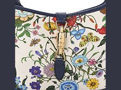 Gucci Canvas Flora Jackie O Hobo with blue agata leather trim features the iconic flora/fauna canvas known from the designer house. This stylish hobo features bright floral canvas with coordinating blue agata leather accents. Features a looping leather shoulder strap with a light brass buckle and a cross over strap with a light brass piston. This opens to a natural linen interior with space for daytime essentials.    Model: 550152  White floral canvas with Agata blue leather trim   Interior lini Gucci Canvas Bag With Adjustable Strap, Gucci Multicolor Tote Bag, Gucci Multicolor Shoulder Bag For Daily Use, Gucci Canvas Top Handle Shoulder Bag, Gucci Canvas Bags With Gold-tone Hardware, Blue Gucci Shoulder Bag For Everyday Use, Gucci Canvas Bag With Leather Handles, Blue Gucci Travel Bag, Blue Gucci Shoulder Bag With Detachable Strap