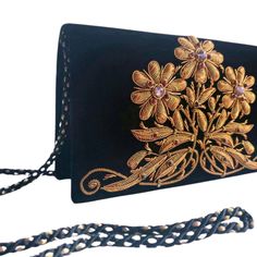 "Exquisite black velvet evening bag, hand embroidered in the zardozi style with copper colored metallic flowers and embellished with genuine amethysts, to create an opulent, dazzling 3D effect. The matte copper threads change to shiny at the tips of the flowers and the leaves. Add an eye-catching pop of color, texture and sparkly bling to your overall party look. It is just the right size to hold your essentials for the night - phone, credit cards, money, keys and lipstick. The shoulder strap ke Hand Embellished Black Evening Bag, Black Hand Embellished Evening Bag, Elegant Hand Embellished Black Bag, Elegant Black Hand-embellished Clutch, Elegant Black Hand Embellished Clutch, Elegant Black Hand-embellished Bag, Formal Velvet Rectangular Shoulder Bag, Luxury Hand Embellished Black Evening Bag, Luxury Black Hand Embellished Evening Bag