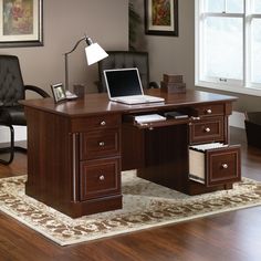 an office desk with two chairs and a lamp