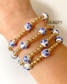 Blue Floral gold beaded bracelet Blue Bangle Jewelry With Large Beads, Dainty Adjustable Gold Beaded Bracelets, Adjustable Gold Plated Beaded Bracelets With Round Beads, Gold Bohemian Wrap Bracelet With Spacer Beads, Gold Wrap Bracelet With Colorful Beads, Gold Bohemian Friendship Bracelets With Spacer Beads, Bohemian Gold Friendship Bracelets With Spacer Beads, Gold Wrap Bracelet With Colorful Beads As Gift, Elegant Beaded Charm Bracelet