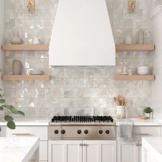 a stove top oven sitting inside of a kitchen next to wooden shelves and white counter tops