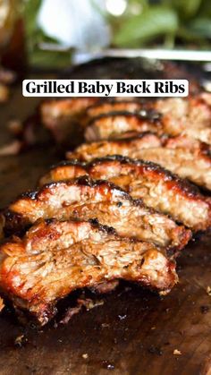 grilled baby back ribs sitting on top of a wooden cutting board with text overlay