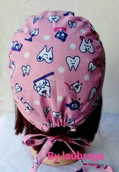 the back of a woman's head wearing a pink hat with dogs on it