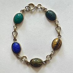 12k Gold Filled Bracelet Vintage Egyptian Revival Beetle 5 Carved Scarab Gemstones Onyx, Blue And Green Chalcedony, Tiger Eye Stones Length About 7 Inches Scarab Bracelet, Green Chalcedony, Egyptian Revival, Bracelet Vintage, Tiger Eye Stone, Tiger Eye, Womens Jewelry Bracelets, Gold Filled, Onyx