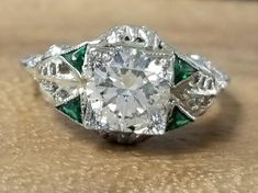 A stunning Vintage Art Deco filigree  round  shape Diamond 20k white  gold engagement ring  circ 1920's center natural  round diamond weight 1.24ct. SIZE 6.6mm SI1-J  color the center diamond  bright color ,VERY LIVELY, NICE CUT,CLEAN, Side set natural emerald weight 0.25ct.Ring size 6Resizable This tremendous old vintage ring is in a very good condition. Fabulous vintage piece in good condition Appraisal available Retail Value $11,500 net. Victorian White Diamond Ring, Victorian Style White Diamond Round Ring, White Victorian Style Round Diamond Ring, Art Deco Filigree Wedding Ring, Art Deco Diamond Ring With Filigree, Victorian White Round Diamond Ring, Art Deco Filigree Ring With Intricate Design, White Diamond Ring With Filigree, Art Deco Filigree Ring With Diamond Accents