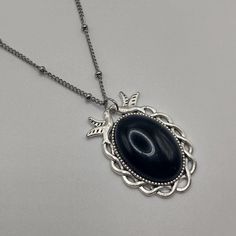 Gemstone pendant on silver tone necklace Handmade ✨ Black Agate✨  Silver tone mixed metal - not sterling silver Pendant size: approx 20 x 30 mm Gemstone cabochon size: 18 x 25mm Necklace length:  ✨ 20 inch/50cm ✨ 24 inch/60cm Made with natural gemstones - markings and patterns will vary slightly from pendant to pendant, making each one beautifully unique Complete in gift bag Silver Necklace With Large Oval Pendant, Nickel Free Silver Agate Necklaces, Silver Necklace With Large Oval Cabochon Stone, Metal Pendant Necklaces With Cabochon, Metal Cabochon Pendant Necklace, Metal Pendant Necklace With Cabochon, Nickel Free Silver Agate Necklace, Silver Teardrop Pendant Necklace With Cabochon, Elegant Black Cabochon Necklace