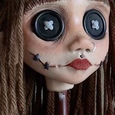 a creepy looking doll with big eyes and long dreadlocks on it's head