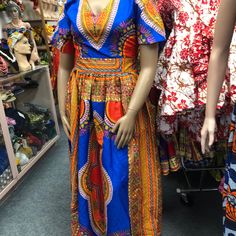 African Clothing For Women Danshiki Ankara Print Handmade Long Dress. Blue Background Mannequin Is Wearing. Size 10 Contact Me For Questions About This Dress Traditional Multicolor V-neck Maxi Dress, V-neck Batik Print Festival Dress, Bohemian Blue Dress With Colorful Pattern, Blue Bohemian Dress With Colorful Pattern, Blue Floor-length Maxi Dress For Festival, V-neck Batik Print Dress For Festival, Traditional Floral Print Maxi Dress With Short Sleeves, Traditional Short Sleeve Maxi Dress With Floral Print, Multicolor Short Sleeve Dress For Festivals