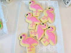 decorated cookies in the shape of pink flamingos