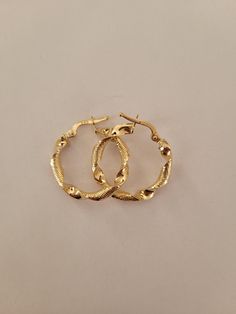 Elevate your style with these exquisite Solid Gold Twisted Hoop Earrings. Crafted from high-quality 14k gold, these earrings feature a unique twisted design that adds a modern twist to the classic hoop. The textured finish gives them a sophisticated look, making them a standout piece in any jewelry collection. Perfect for both everyday wear and special occasions, these hoop earrings are versatile and elegant. They make an exceptional gift for birthdays, anniversaries, or any celebration where yo Small Hoop Earrings For Formal Events, Formal Small Hoop Pierced Earrings, Metal Hoop Jewelry For Anniversary, Anniversary Hoop Jewelry In Metal, Clip-on Hoop Earrings For Anniversary, Anniversary Hoop Metal Jewelry, Elegant Hoop Wrap Earrings For Anniversary, Yellow Gold Clip-on Hoop Earrings, Small Hoop Hinged Earrings For Anniversary