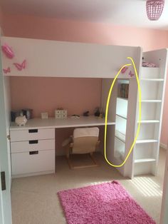 a room with pink carpet and white furniture in the corner, there is a yellow circle on the wall