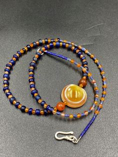 The beautiful ancient old Luk Mik or magic eye bead from Himalaya Tibet along with some blue ancient glass beads along with some orange color carnelian and lapis beads as spacers in the mala necklace Lukmik means goat's eye These ancient stones can be in Carnelian and Agate forms and are natural good condition we provide fast and free shipping service world wide Czech Glass Spiritual Beads, Spiritual Czech Glass Round Beads, Handmade Blue Amulet Beads, Amber Amulet Beaded Necklace For Healing, Blue Carnelian Spiritual Jewelry, Spiritual Blue Carnelian Jewelry, Magic Eyes, Carnelian Beads, Mala Necklace