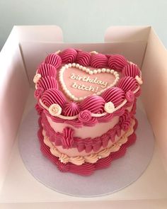 a heart shaped birthday cake in a pink box with the words happy birthday written on it