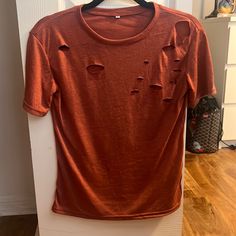 Burnt Orange Color Ripped T-Shirt ( Rips Are Pictured) Size Small Never Worn Red Distressed Crew Neck T-shirt, Red Distressed Crew Neck Top, Casual Red Distressed Tops, Red Distressed Cotton Top, Red Distressed Short Sleeve T-shirt, Orange Tshirt, Ripped Tshirt, Burnt Orange Color, Picture Sizes