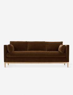 a brown couch with two pillows on it