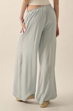 Solid, lightweight woven pants. Drawstring paperbag waist with ruffle and wooden bead accents. Elastic-back waist. Side seam pockets. Wide leg. Partial thigh-length lining. Ankle length. Loose fit. 100% Rayon. Imported. Designed in LA. Model wears size S. Palazzo Pants, Walk On, Ankle Length, Chambray, Wooden Beads, Wide Leg, Loose Fitting, Pants, How To Wear