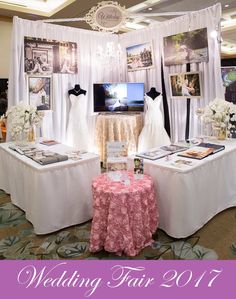 a wedding fair is set up in the middle of a room with white drapes