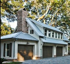 a large white house with two garages