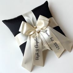 a black and white pillow with a bow on it that says, save the date