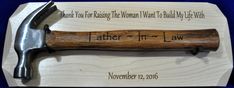 an old hammer with the words father and law written on it next to a plaque