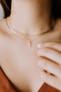 Where everyday elegance meets personal significance, our Cross Necklace is a beautifully delicate statement of faith. Its refined design adds a touch of grace to any outfit while holding deep, personal meaning.∙ D E T A I L S ∙ - 18K Gold Filled - 16 ,18 or 20 inches in length - Hypoallergenic (lead + nickel free) ∙ G O L D ∙ F I L L E D ∙ Gold-filled components contain 100+ times more real gold than gold-plated components and are both durable and tarnish resistant. It is more affordable and accessible than solid gold but higher quality than gold plated. Cross Necklace Gold, Necklaces Simple, Dainty Cross Necklace, Cross Necklaces, Unique Pendant Necklace, Everyday Elegance, Jewelry Essentials, Gold Filled Ring, D F