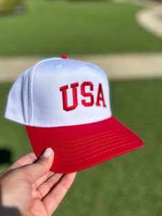 Grab your new favorite Western Two Tone Trucker Hat for summer with our "USA" Red Five panel SnapBack two tone hat. Perfect to watch the summer games, celebrate 4th of July or show your patriotic side this summer. ---------------------- Product Details: 5 Panel Snapback White and Red Brim Natural and Red Sold Out * Classic snapback cap with premium wool blend fabric * Hard buckram. Structured * Contrasting plastic snapback closure * Contrasting eyelets and top button * ---------------------- Product Features: - Material: 8 oz./yd² (US) 13.3 oz., 50/50 cotton/polyester blend, with 20 singles - Heather Sport colors feature a 60/40 polyester/cotton blend - Classic fit for comfortable wear - 1x1 rib with spandex for enhanced stretch and recovery - Tear away label for added convenience -------- Patriotic Snapback Baseball Cap For Summer, Patriotic Snapback Summer Hats, Patriotic Snapback Hat For Summer, White Curved Brim Baseball Cap For 4th Of July, White Adjustable Baseball Cap For 4th Of July, Red Baseball Cap For 4th Of July, White Baseball Cap For 4th Of July, Adjustable White Baseball Cap For 4th Of July, Casual White Baseball Cap For 4th Of July