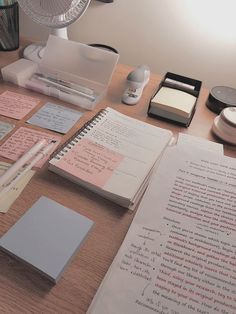 the desk is cluttered with notes, pens, and other office supplies on it