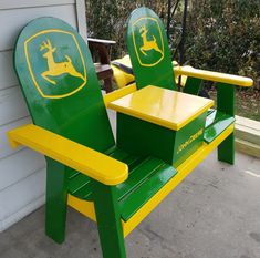 two green and yellow lawn chairs sitting on top of a cement floor next to a white house